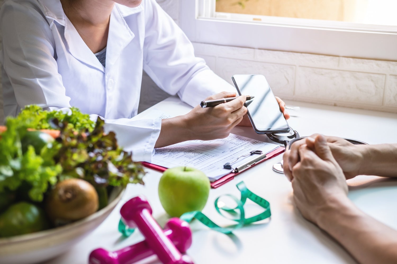 Doctor talking to patient with phone in hand